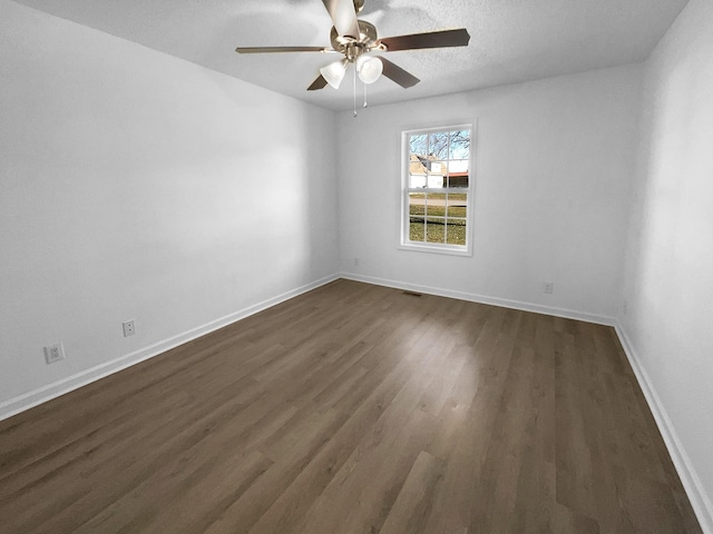 spare room featuring a textured ceiling, ceiling fan, and dark hardwood / wood-style floors