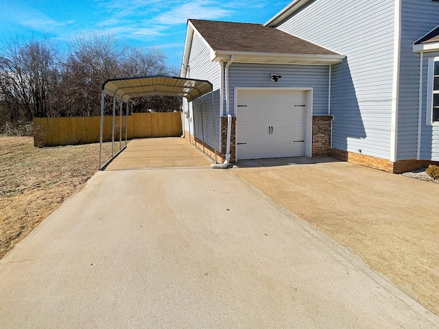 view of side of property with a carport and a garage