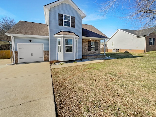 back of house with a garage and a lawn