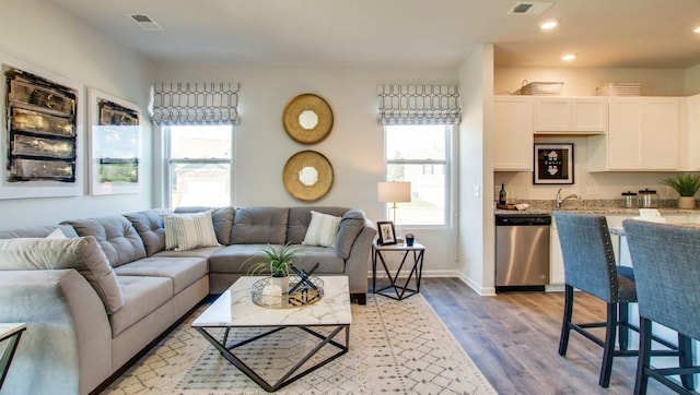 living room featuring light hardwood / wood-style flooring and a wealth of natural light