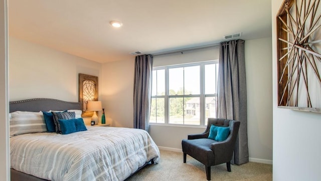 carpeted bedroom featuring multiple windows