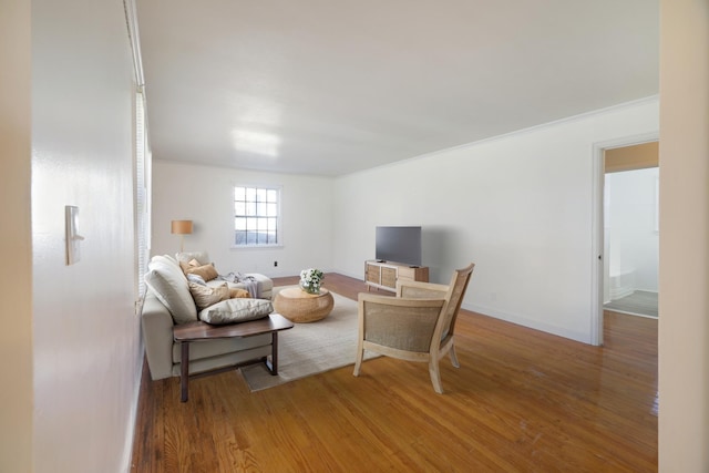 living room featuring hardwood / wood-style flooring and ornamental molding