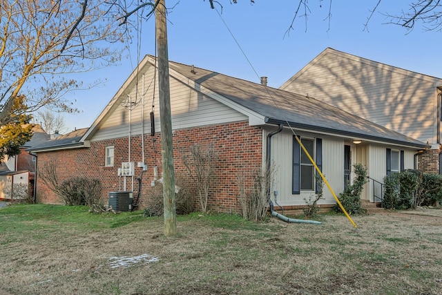 back of house featuring central AC and a lawn