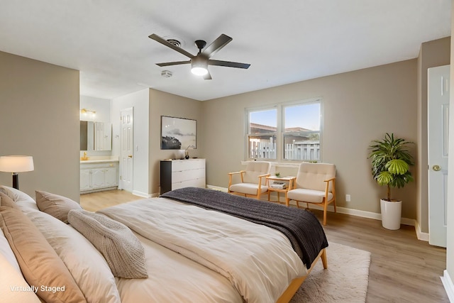 bedroom with ceiling fan, light hardwood / wood-style floors, and ensuite bath