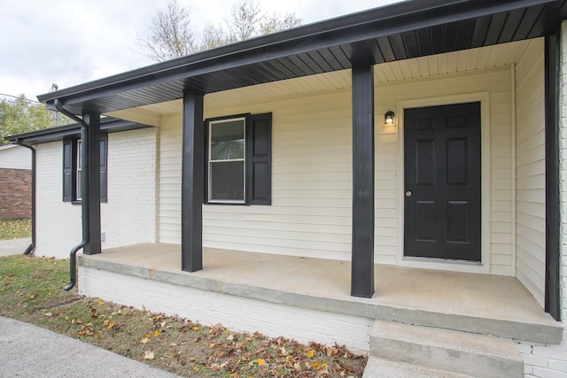 view of exterior entry with covered porch