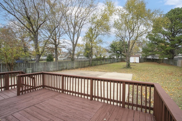 wooden deck with a yard and a storage shed