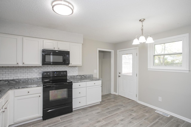 kitchen featuring backsplash, black appliances, white cabinets, an inviting chandelier, and decorative light fixtures