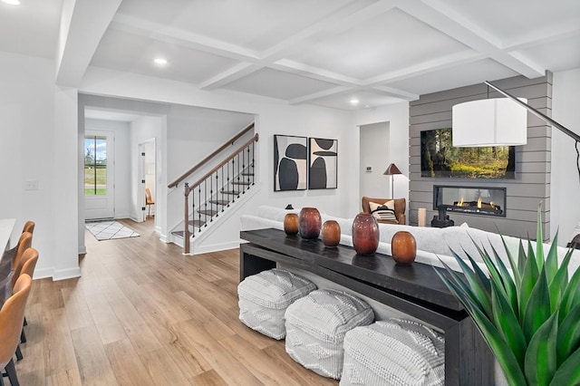 living room with coffered ceiling, light hardwood / wood-style floors, and beamed ceiling