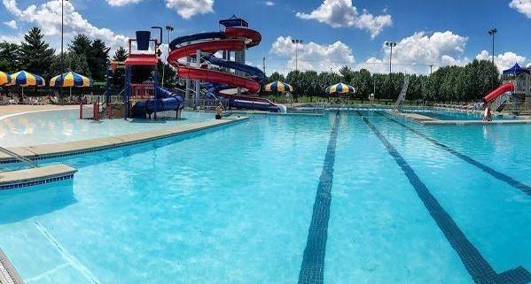 view of swimming pool featuring a water slide and a playground