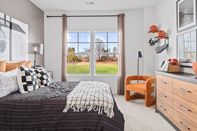 bedroom featuring light carpet