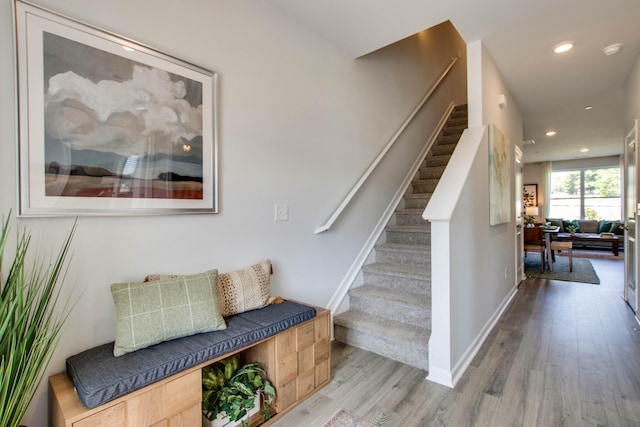 stairway with hardwood / wood-style flooring