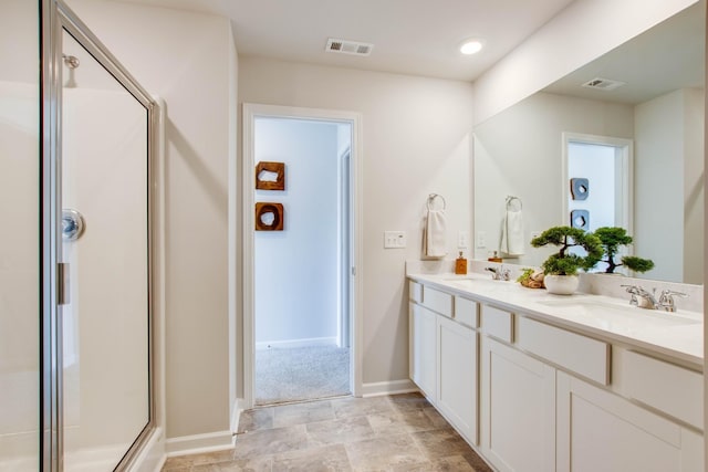 bathroom with vanity and a shower with shower door