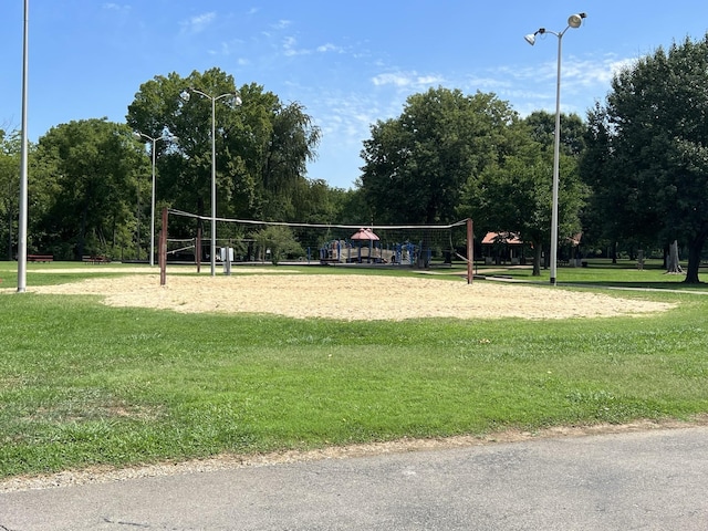 view of community with volleyball court and a yard