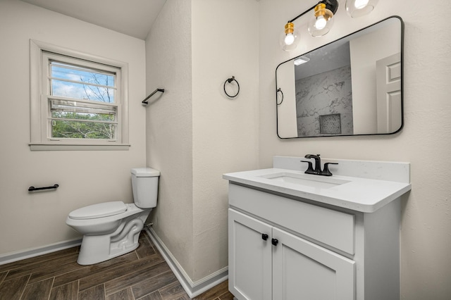 bathroom featuring toilet and vanity