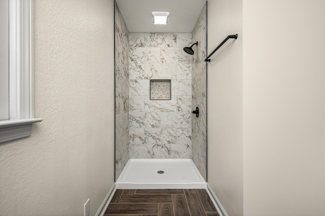 bathroom with tiled shower