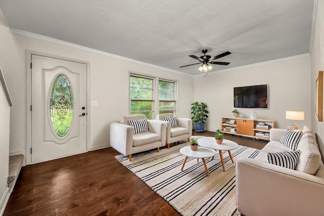 living room featuring dark wood-type flooring, ceiling fan, and crown molding