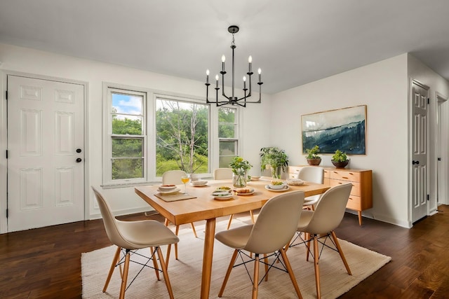 dining space featuring a notable chandelier and dark hardwood / wood-style flooring