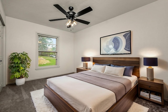 bedroom with a closet, ceiling fan, and dark colored carpet