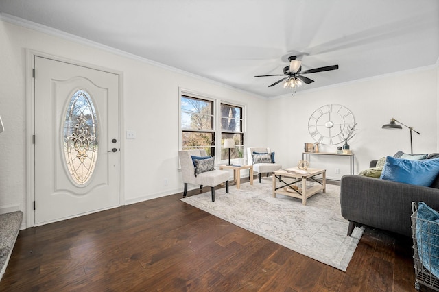 entryway featuring ceiling fan, baseboards, wood finished floors, and crown molding