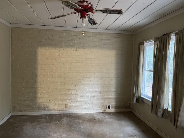 unfurnished room featuring ceiling fan, brick wall, and concrete floors