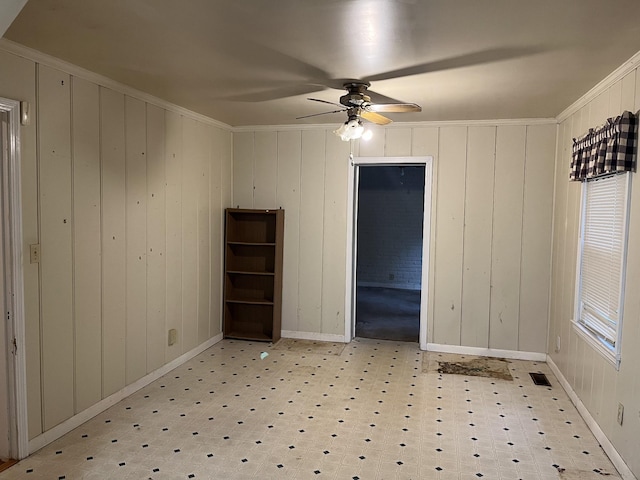 unfurnished room featuring ornamental molding and ceiling fan