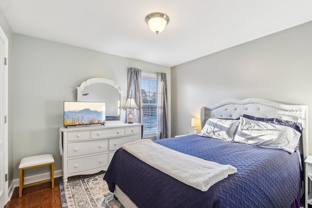 bedroom with dark wood-type flooring