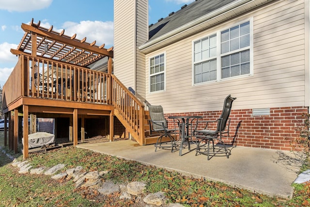 rear view of property featuring a patio and a deck