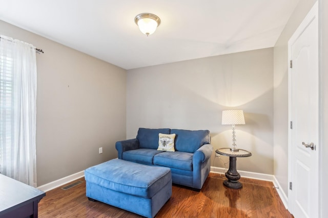 sitting room with dark wood-type flooring