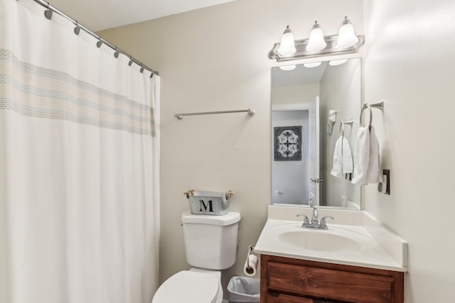 bathroom with a shower with curtain, vanity, and toilet