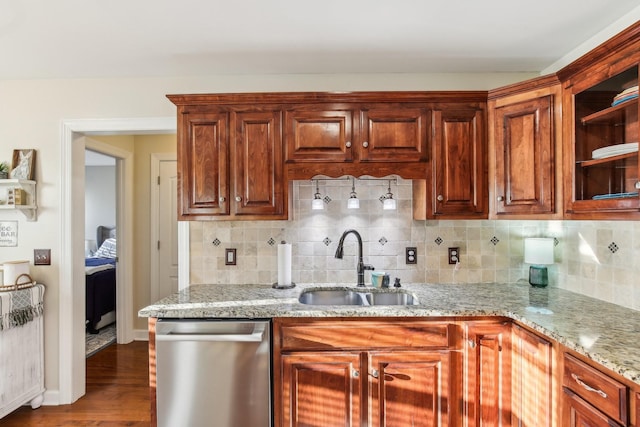 kitchen featuring dishwasher, light stone countertops, dark hardwood / wood-style flooring, sink, and tasteful backsplash