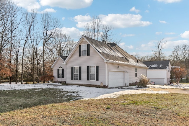 view of property featuring a front yard and a garage