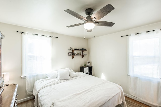 bedroom with ceiling fan and dark wood-type flooring