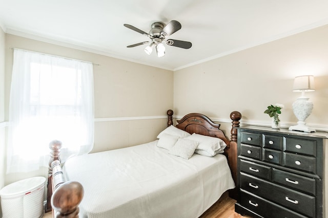 bedroom featuring wood-type flooring, ceiling fan, and crown molding