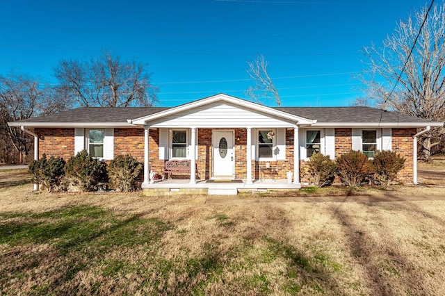 ranch-style home with a porch and a front yard