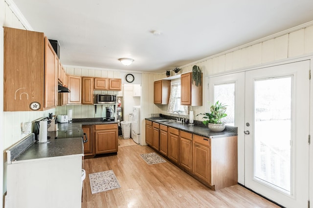 kitchen with sink, french doors, light wood-type flooring, and ornamental molding