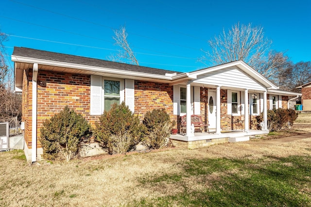 ranch-style home with a front yard and covered porch