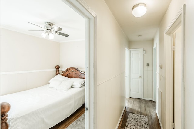 bedroom with dark hardwood / wood-style flooring and ceiling fan