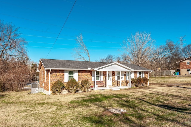 single story home featuring covered porch and a front lawn