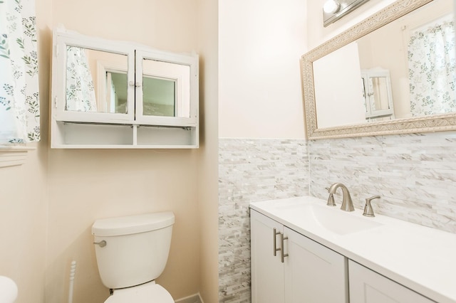 bathroom featuring toilet and vanity