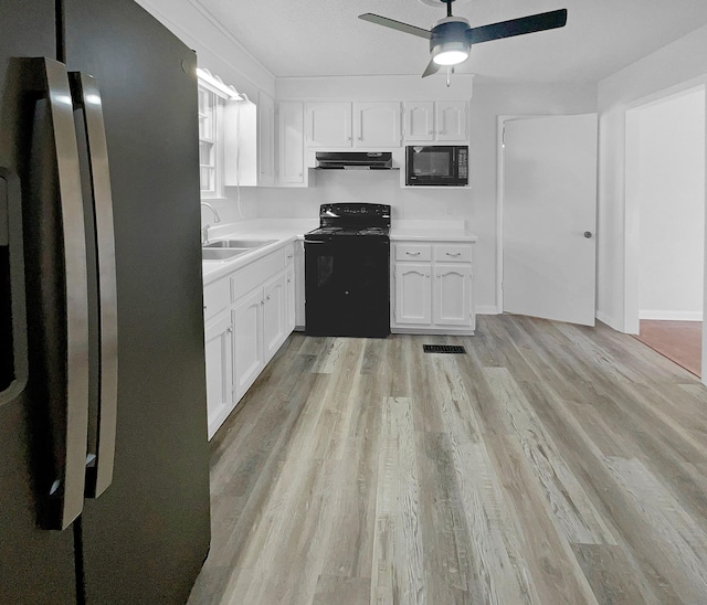 kitchen with sink, white cabinetry, ceiling fan, light hardwood / wood-style flooring, and black appliances