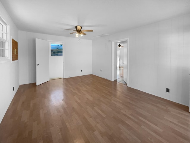 empty room with ceiling fan and wood-type flooring