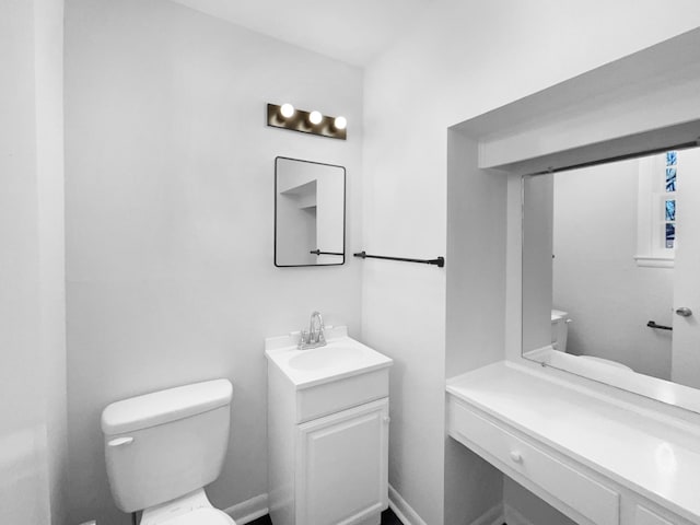 bathroom featuring toilet and vanity