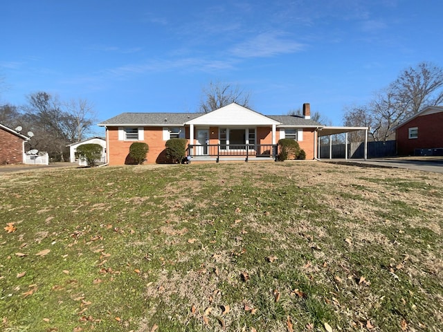 single story home featuring a front yard, a porch, and a carport