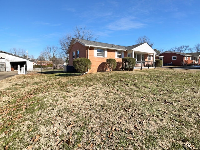 view of property exterior featuring an outbuilding, a garage, a porch, and a yard