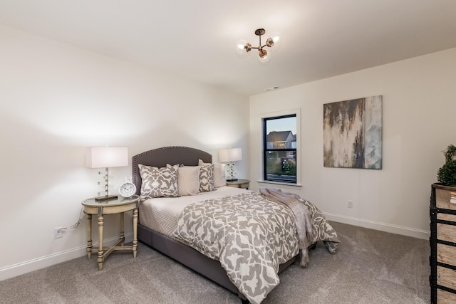 bedroom featuring carpet and a chandelier