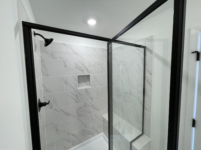 bathroom with a shower with shower door