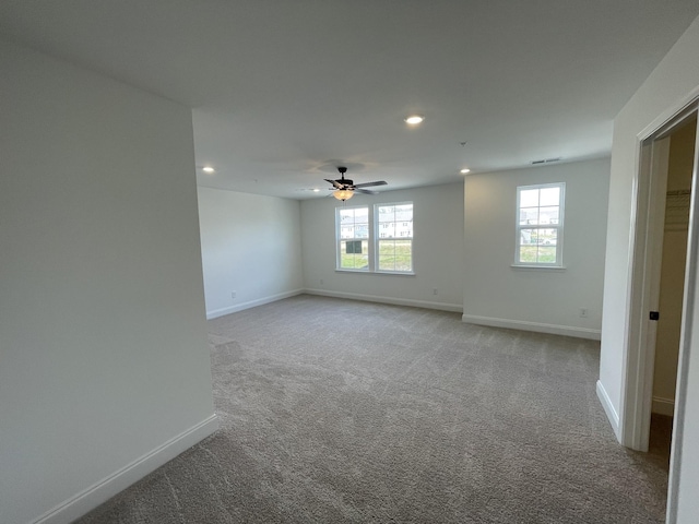 unfurnished room featuring light carpet and ceiling fan