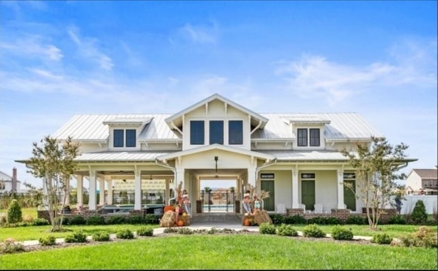 back of house featuring a yard and covered porch