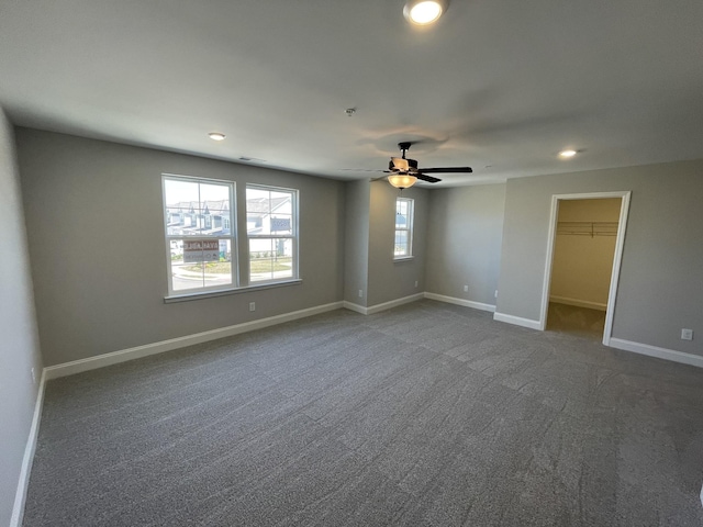 carpeted empty room featuring ceiling fan