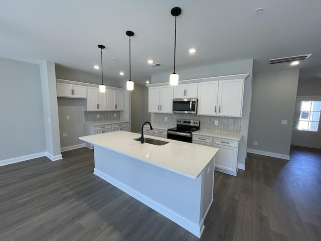 kitchen with sink, white cabinetry, an island with sink, and black / electric stove